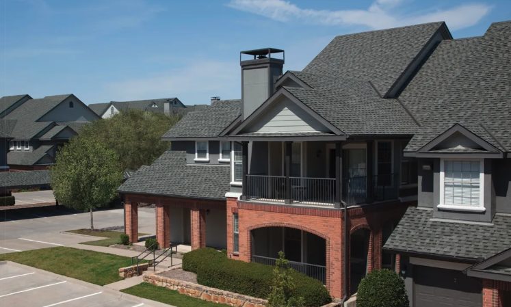 A two-storey home roofed with dark architectural asphalt shingles